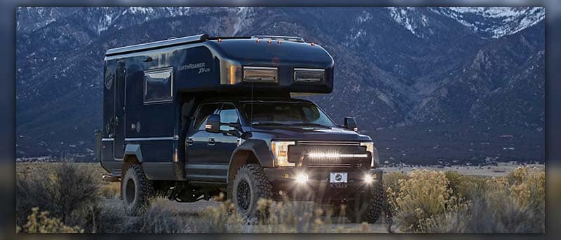 EarthRoamer XV-LTS rugged expedition vehicle parked in a remote wilderness area surrounded by pristine nature.